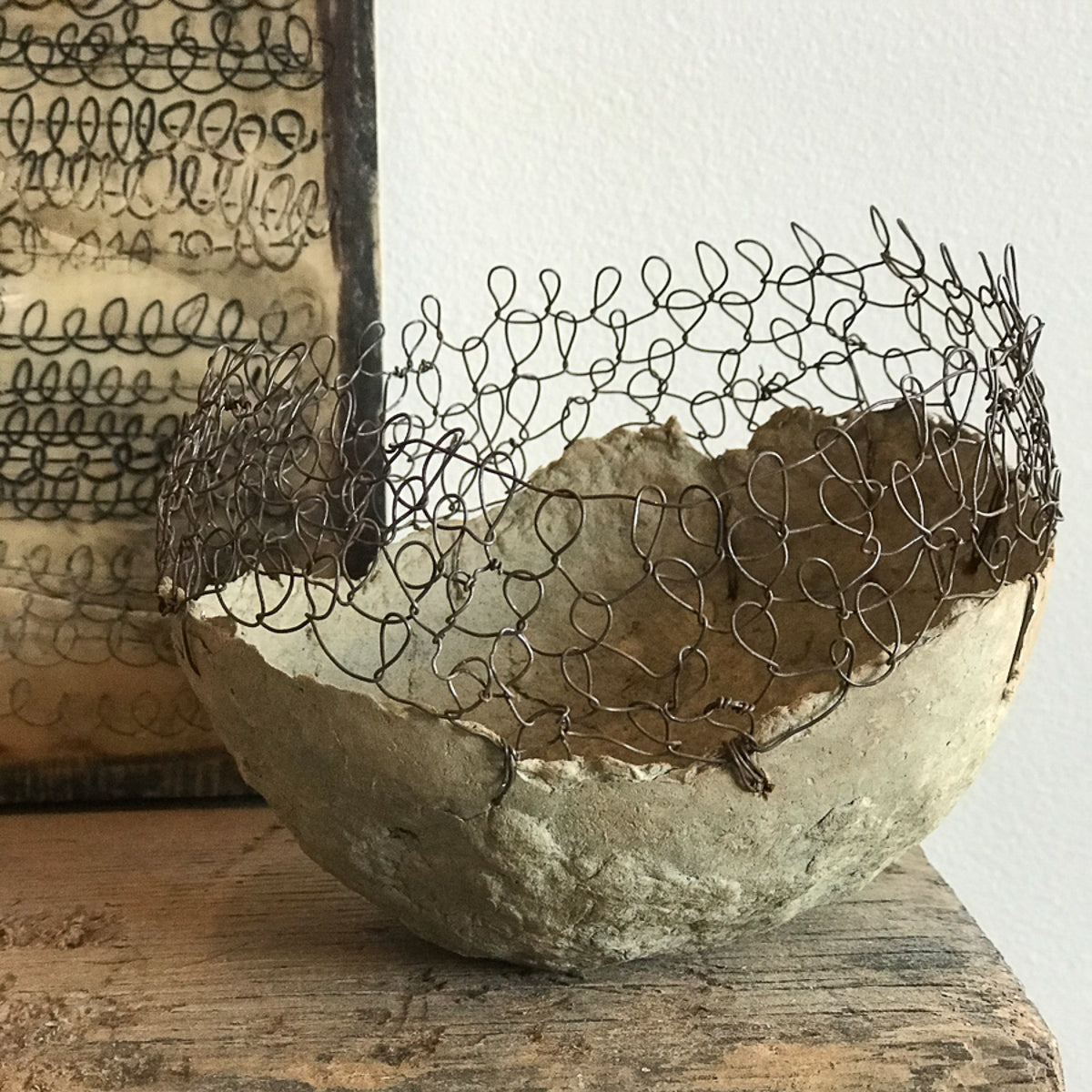 Vessel Study No. 38, handmade with recycled cardboard boxes and wire. A one-of-a-kind Jennifer Alden Design contemporary sculpture. Encaustic etched loop painting in background.