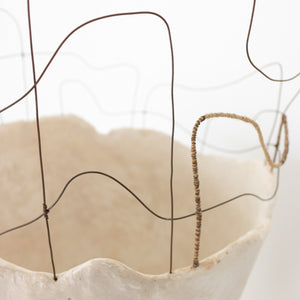 Handmade by artist Jennifer Alden Design, Vessel Study No. 43 is a contemporary sculpture made from paper clay, plaster, paint and wire. This sculpture is designed for tabletop or floor placement. Each unique vessel in this collection is one-of-a-kind, rare, and both primitive and modern. Close-up detail of wire weaving and wrapping.